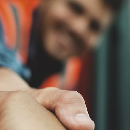 Mitarbeiter schüttelt Hand aus dem Zug