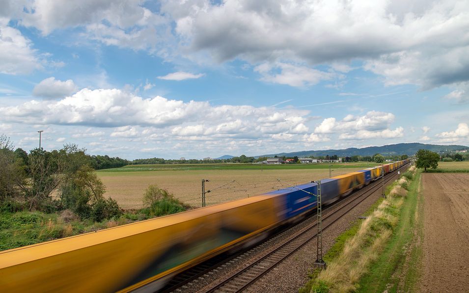 Container train travels through fields